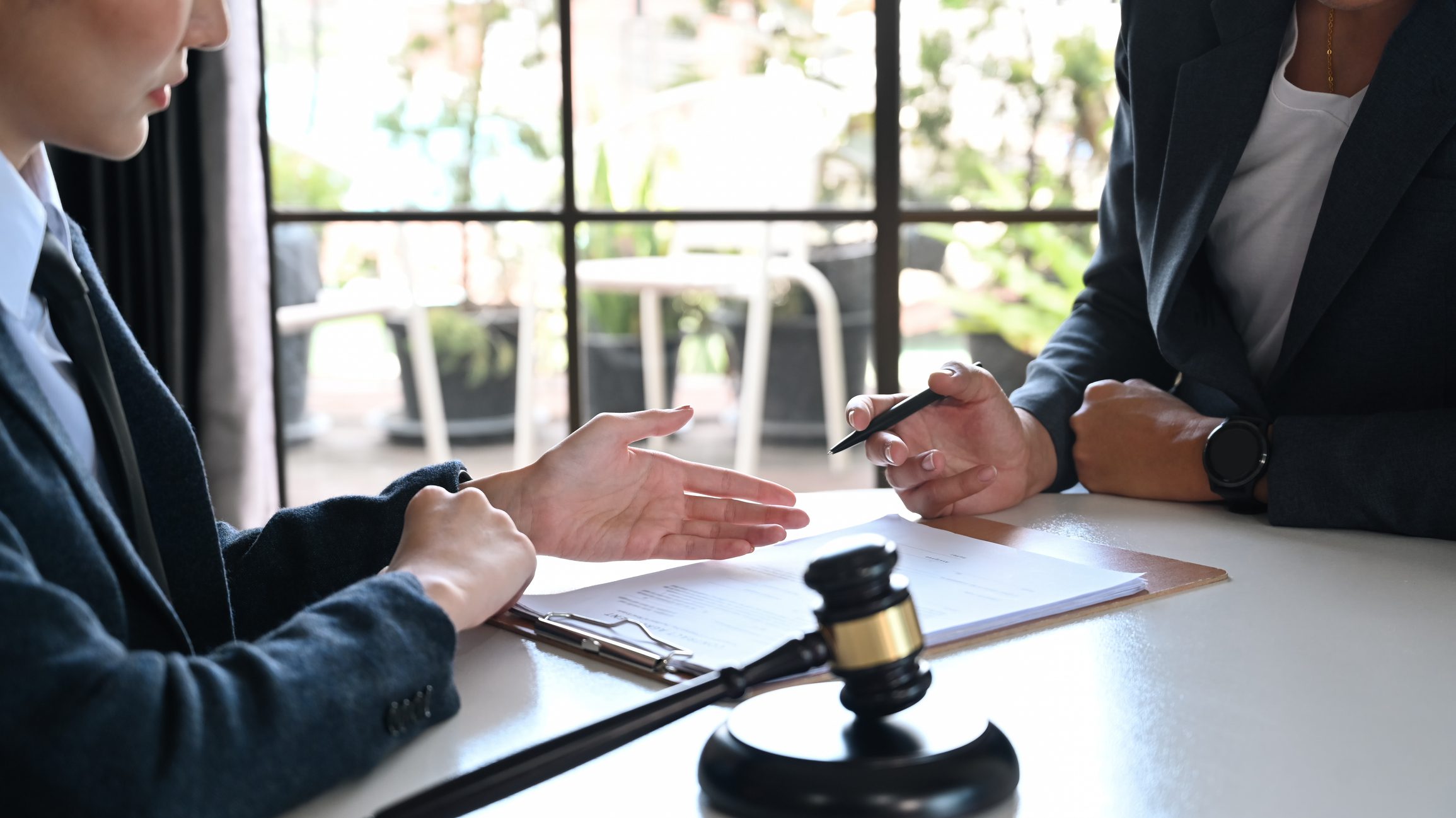 Female lawyer explaining terms, condition on legal document to client before signing on contract at law firm. Female lawyer explaining terms, condition on legal document to client before signing on contract at law firm.